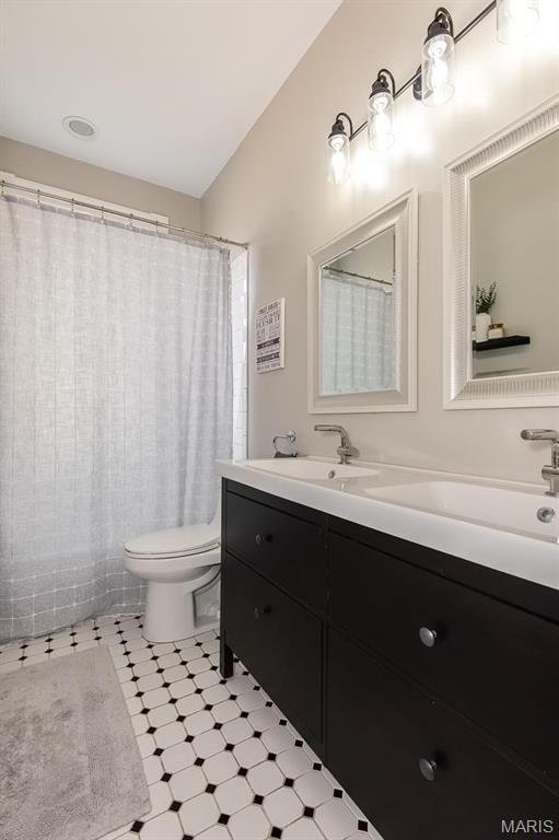 2712 Potomac St, Saint Louis, MO 63118 - bathroom with tile patterned floors, toilet, and vanity