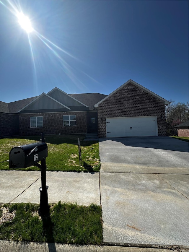 12 Creekside Way, Cape Girardeau, MO 63701 - ranch-style house with brick siding, concrete driveway, an attached garage, and a front lawn