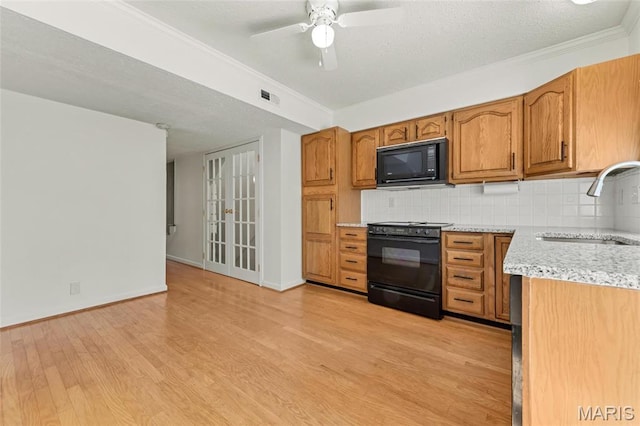 13355 Land O Woods Dr, Saint Louis, MO 63141 - kitchen featuring black appliances, a sink, light wood-style flooring, decorative backsplash, and brown cabinetry