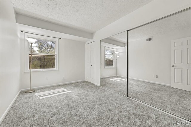 13355 Land O Woods Dr, Saint Louis, MO 63141 - unfurnished bedroom featuring a textured ceiling, carpet, a closet, and baseboards