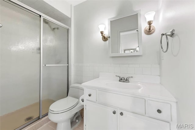 13355 Land O Woods Dr, Saint Louis, MO 63141 - bathroom featuring a stall shower, vanity, toilet, tile walls, and tile patterned floors