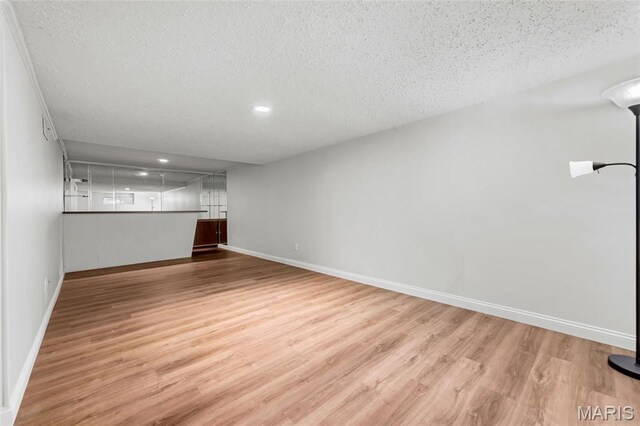 13355 Land O Woods Dr, Saint Louis, MO 63141 - basement with a textured ceiling, light wood-style floors, baseboards, and recessed lighting