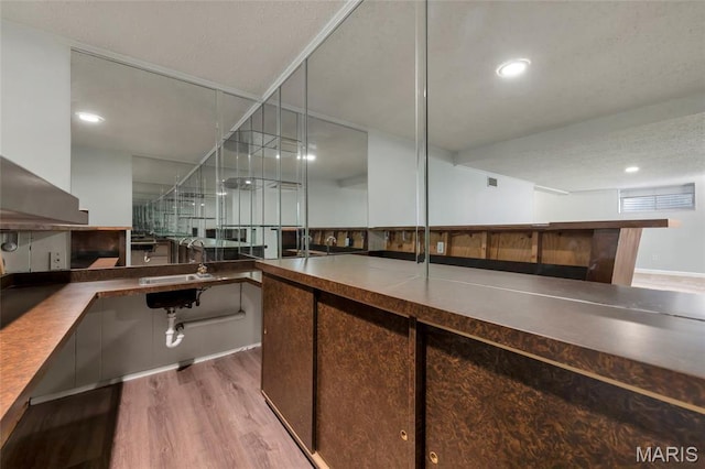 13355 Land O Woods Dr, Saint Louis, MO 63141 - bar featuring wood finished floors, a sink, and recessed lighting