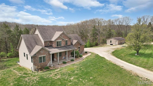 9336 Excelsior Rd, Gerald, MO 63037 - view of front facade featuring a porch, dirt driveway, brick siding, a forest view, and a front lawn