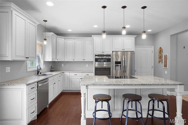 9336 Excelsior Rd, Gerald, MO 63037 - kitchen featuring appliances with stainless steel finishes, a sink, a center island, white cabinetry, and recessed lighting