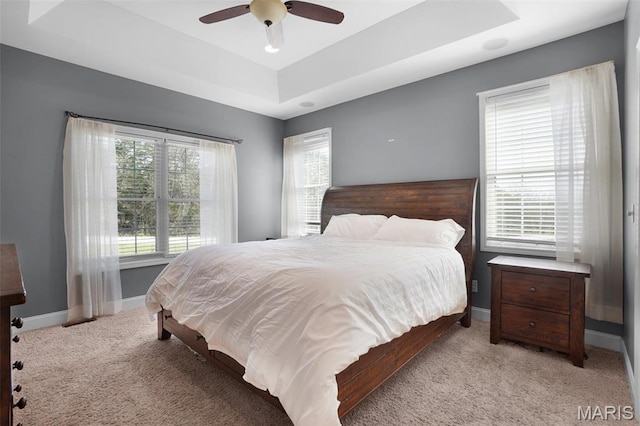 9336 Excelsior Rd, Gerald, MO 63037 - bedroom with light carpet, a tray ceiling, baseboards, and ceiling fan