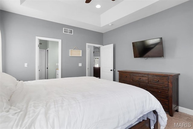 9336 Excelsior Rd, Gerald, MO 63037 - carpeted bedroom with a tray ceiling, baseboards, ceiling fan, and ensuite bath