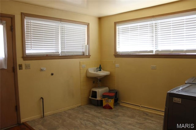 washroom with washer / dryer and a baseboard radiator