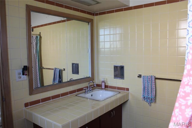 bathroom with tile walls and vanity