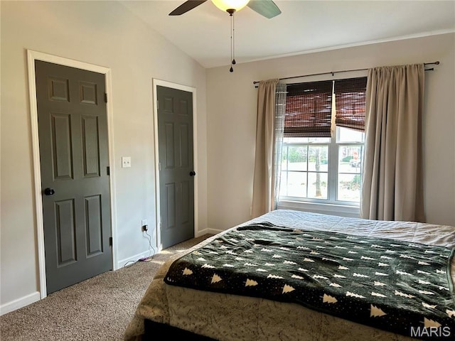 carpeted bedroom with baseboards, ceiling fan, and lofted ceiling