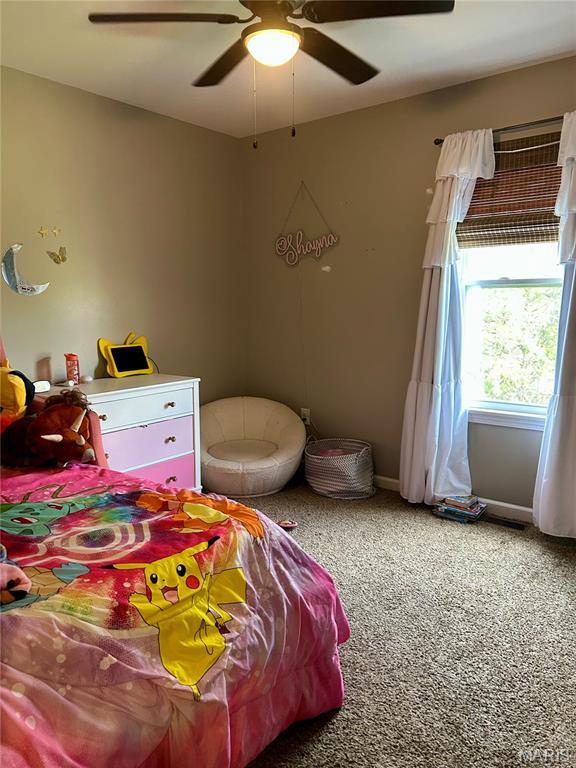 bedroom featuring light colored carpet and ceiling fan