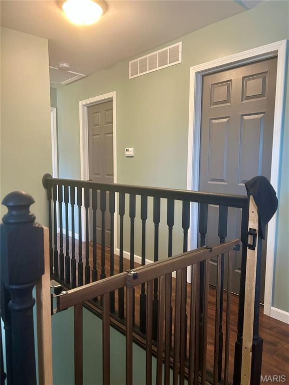 stairs with wood finished floors and baseboards