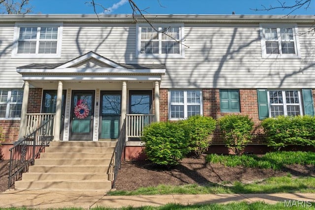 1551 Swallow Dr, Saint Louis, MO 63144 - view of front of property featuring brick siding and covered porch