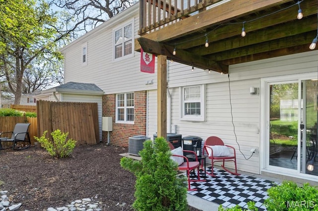 1551 Swallow Dr, Saint Louis, MO 63144 - back of house featuring fence, brick siding, cooling unit, and a patio