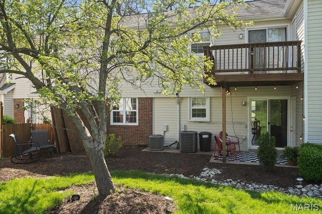 1551 Swallow Dr, Saint Louis, MO 63144 - back of property featuring a patio, central air condition unit, fence, and a balcony