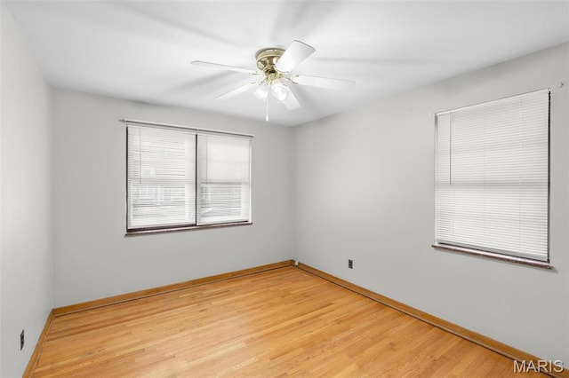 8900 Southview Ln, Saint Louis, MO 63123 - spare room with light wood-style flooring, ceiling fan, and baseboards