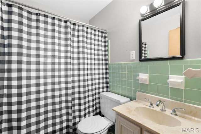 8900 Southview Ln, Saint Louis, MO 63123 - bathroom with tile walls, toilet, vanity, a shower with shower curtain, and a wainscoted wall