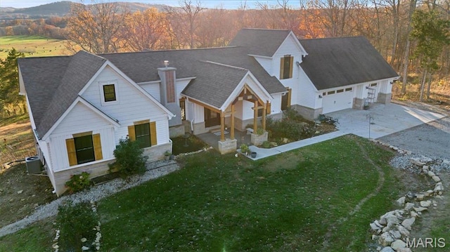 24925 State Route Mm, Farmington, MO 63640 - view of front of home featuring concrete driveway, central AC unit, a chimney, a front yard, and board and batten siding