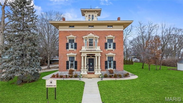 876 W State St W, Jacksonville, IL 62650 - italianate house featuring a chimney, a front yard, and brick siding