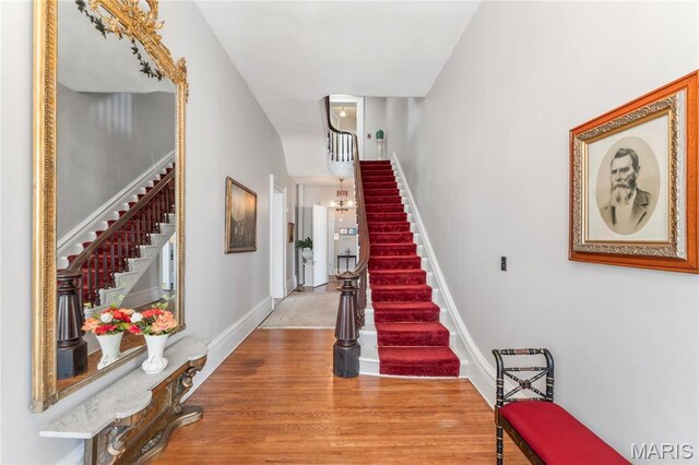876 W State St W, Jacksonville, IL 62650 - stairway with wood finished floors and a chandelier