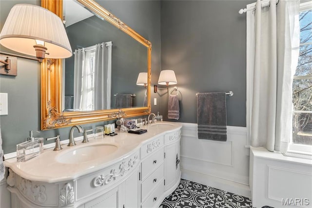 876 W State St W, Jacksonville, IL 62650 - full bathroom featuring a wainscoted wall, double vanity, and tile patterned flooring