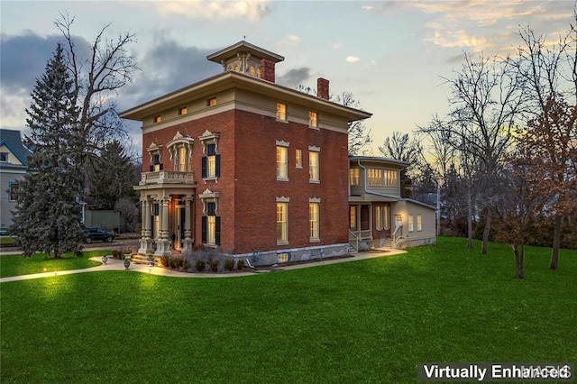 876 W State St W, Jacksonville, IL 62650 - rear view of property with a chimney, a lawn, brick siding, and a balcony