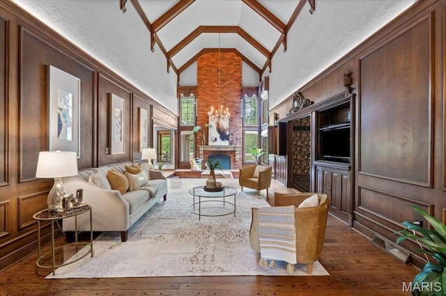 13596 Kings Glen Dr, Saint Louis, MO 63131 - living area featuring high vaulted ceiling, wood-type flooring, and a brick fireplace