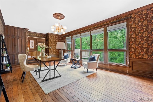 13596 Kings Glen Dr, Saint Louis, MO 63131 - dining room with wallpapered walls, hardwood / wood-style floors, a chandelier, a wainscoted wall, and ornamental molding