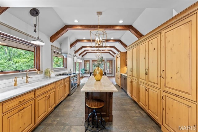 13596 Kings Glen Dr, Saint Louis, MO 63131 - kitchen featuring range with two ovens, a sink, a chandelier, light stone counters, and recessed lighting