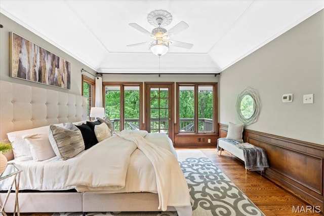 13596 Kings Glen Dr, Saint Louis, MO 63131 - bedroom featuring access to outside, multiple windows, wood finished floors, lofted ceiling, and wainscoting