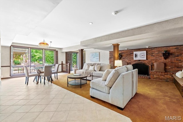 13596 Kings Glen Dr, Saint Louis, MO 63131 - tiled living area with brick wall, a fireplace, carpet, and decorative columns