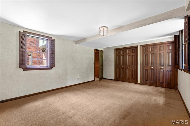 13596 Kings Glen Dr, Saint Louis, MO 63131 - unfurnished bedroom featuring carpet, multiple closets, baseboards, and beam ceiling