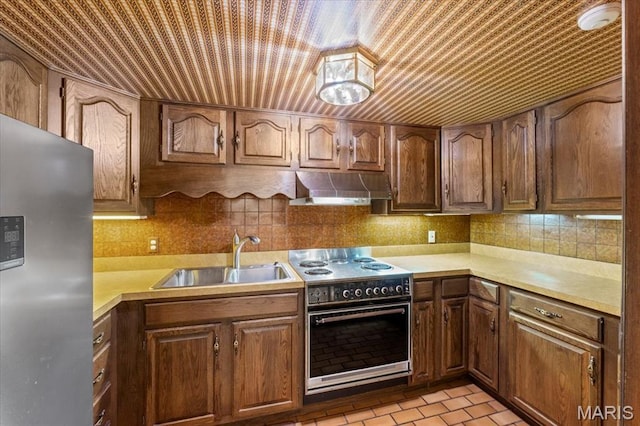 13596 Kings Glen Dr, Saint Louis, MO 63131 - kitchen with stainless steel fridge, electric range oven, a sink, range hood, and light countertops
