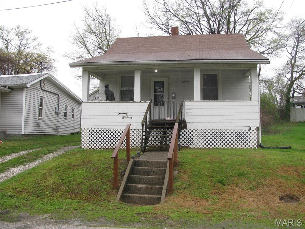 3006 Watalee St, Alton, IL 62002 - bungalow with covered porch, a chimney, a front lawn, and roof with shingles