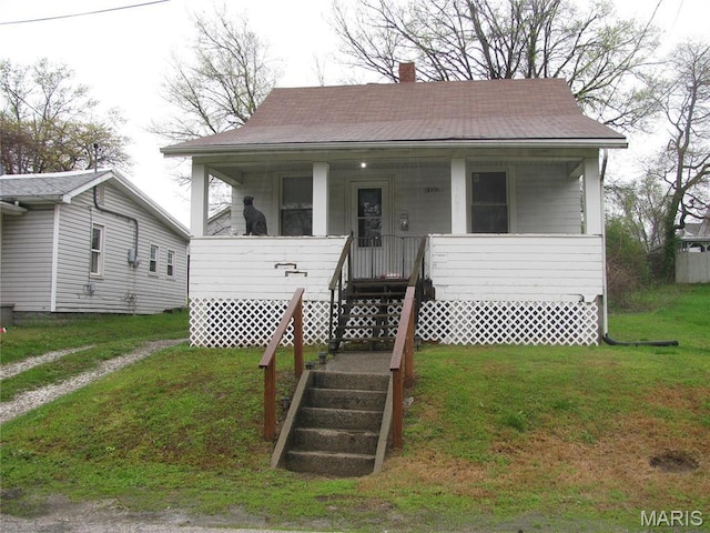 3006 Watalee St, Alton, IL 62002 - bungalow with covered porch, a chimney, a front lawn, and roof with shingles