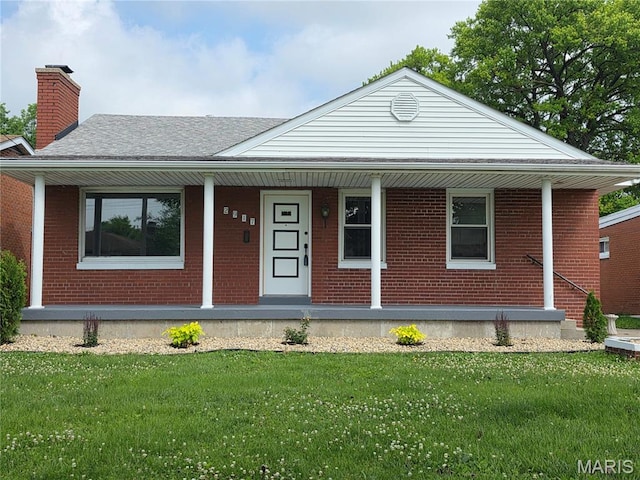 2917 Grand Ave, Granite City, IL 62040 - view of front of home featuring a porch, a chimney, a front yard, and brick siding
