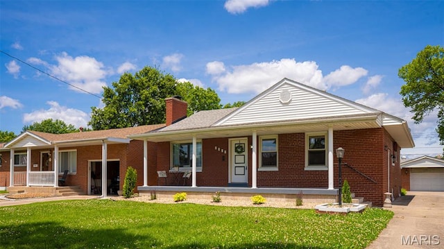 2917 Grand Ave, Granite City, IL 62040 - ranch-style house featuring covered porch, a front lawn, a chimney, and brick siding