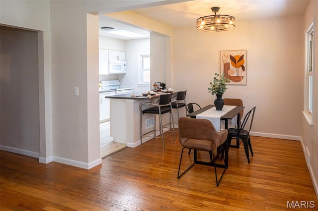 2917 Grand Ave, Granite City, IL 62040 - dining room featuring light wood finished floors and a chandelier