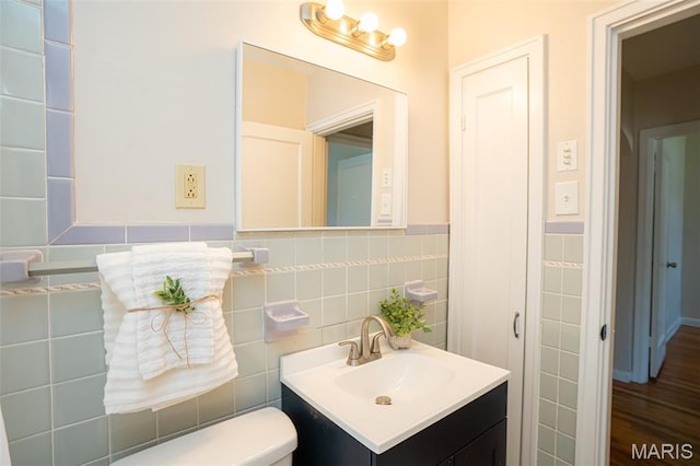 2917 Grand Ave, Granite City, IL 62040 - half bath with vanity, tile walls, and a wainscoted wall