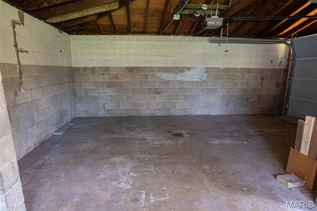 2917 Grand Ave, Granite City, IL 62040 - garage featuring a garage door opener and concrete block wall