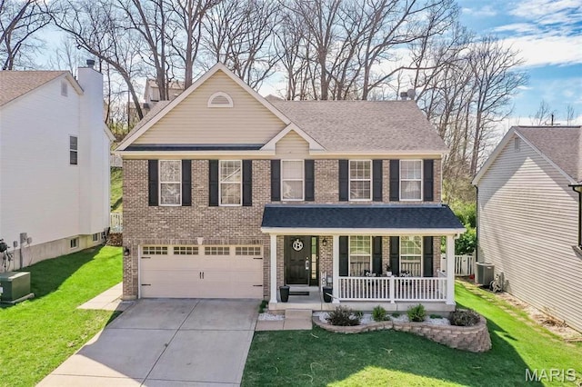 1168 Oak Hollow Dr, Imperial, MO 63052 - traditional home featuring a porch, brick siding, driveway, and a garage