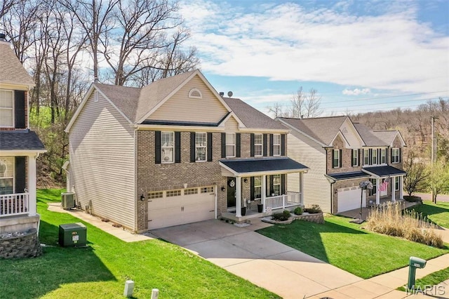 1168 Oak Hollow Dr, Imperial, MO 63052 - view of front of house featuring an attached garage, driveway, brick siding, central AC, and a front lawn