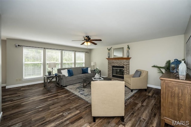 1168 Oak Hollow Dr, Imperial, MO 63052 - living area with dark wood-style flooring, baseboards, ceiling fan, and a brick fireplace