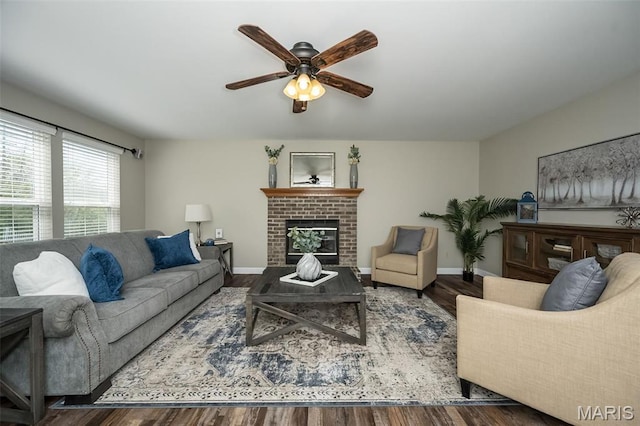 1168 Oak Hollow Dr, Imperial, MO 63052 - living area with a ceiling fan, wood finished floors, a brick fireplace, and baseboards