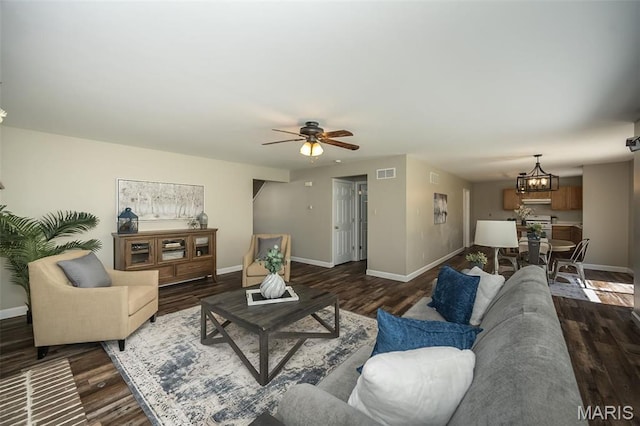 1168 Oak Hollow Dr, Imperial, MO 63052 - living area with dark wood-style floors, a chandelier, baseboards, and ceiling fan