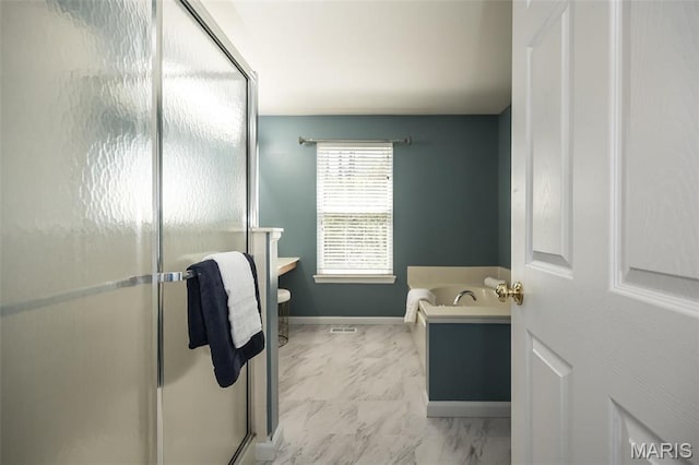1168 Oak Hollow Dr, Imperial, MO 63052 - bathroom with a stall shower, marble finish floors, baseboards, and a tub