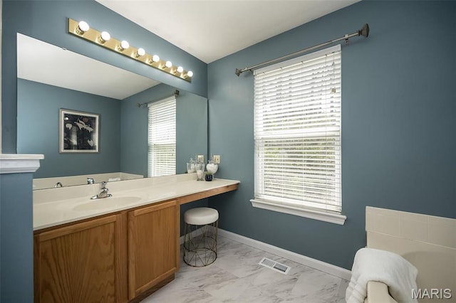 1168 Oak Hollow Dr, Imperial, MO 63052 - bathroom featuring marble look tiles, vanity, and baseboards