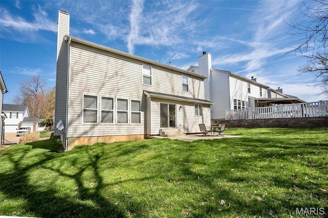 1168 Oak Hollow Dr, Imperial, MO 63052 - rear view of property featuring a chimney, entry steps, a lawn, and a patio area