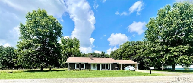 5815 Robin Ln, Troy, MO 63379 - ranch-style home with a front yard, a chimney, and a carport