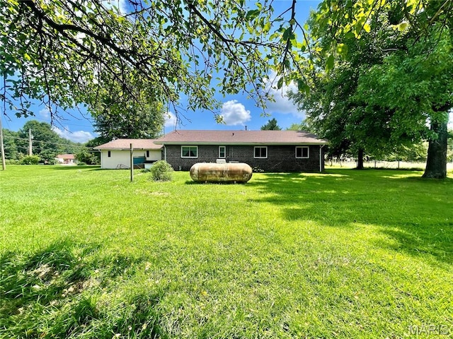 5815 Robin Ln, Troy, MO 63379 - back of house with a yard and brick siding